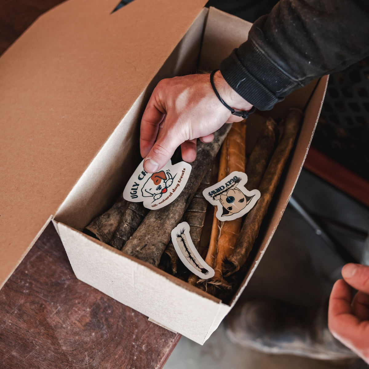 Packing an Ugly Chews order box with chews and stickers