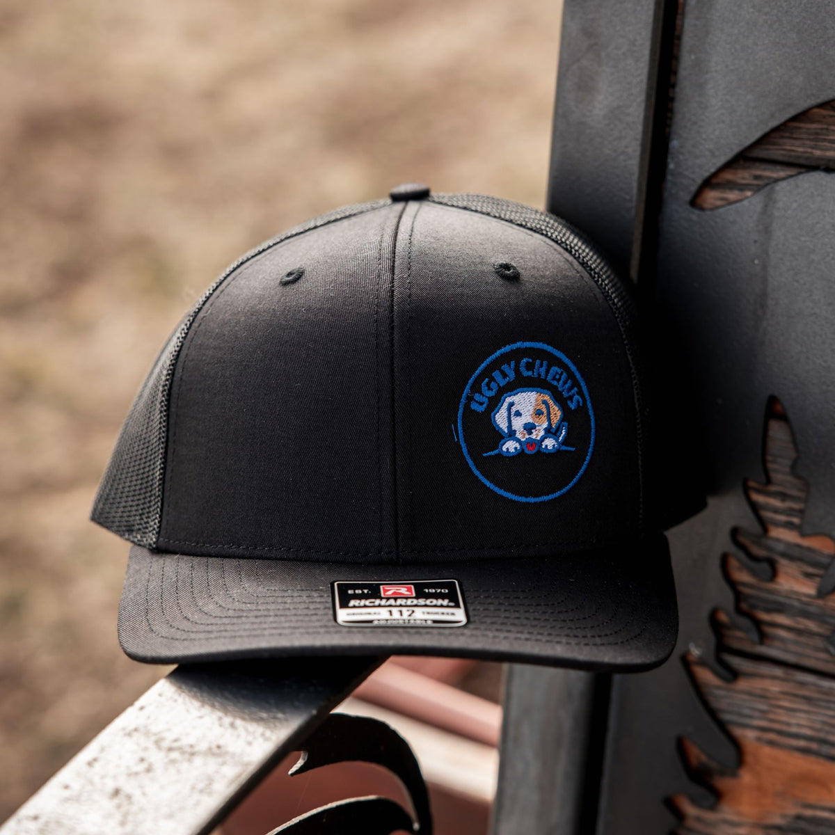 Black Ugly Chews snapback cap on a metal rail